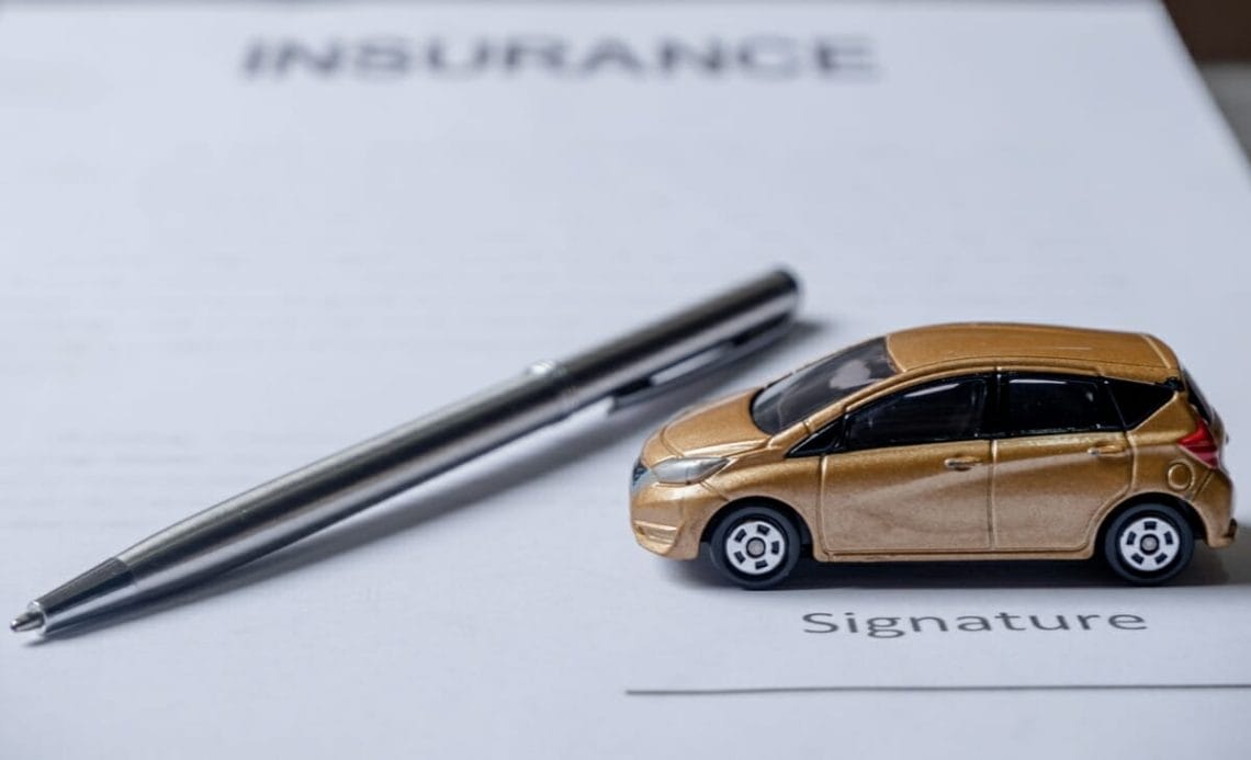 car and pen on insurance documents car insurance 2022 11 16 16 05 36 utc